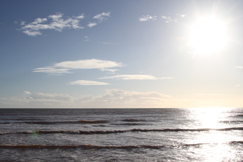 Looking out to sea and seeing small waves approaching the shore