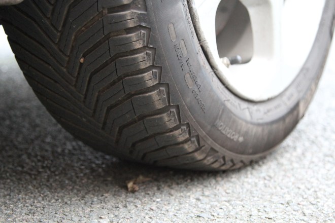 Tyre tread and wheel on asphalt