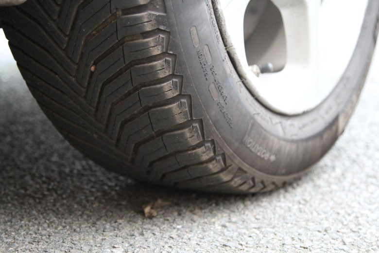 Tyre tread and wheel on asphalt
