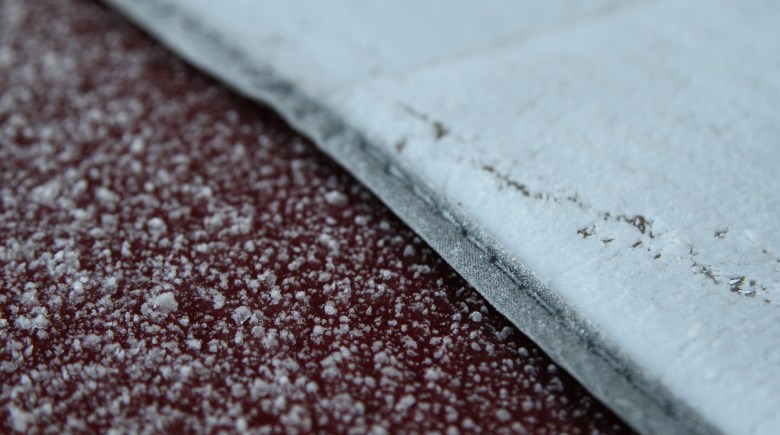 Windscreen blanket covered with ice